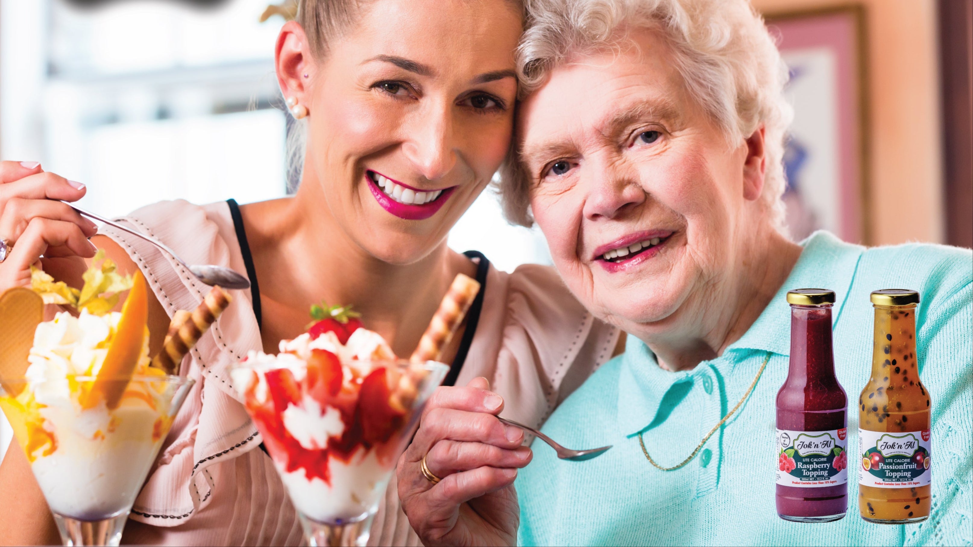 Two women enjoying ice cream with Jok'n'Al logo and bottles in the background.
